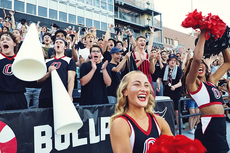 cheerleaders and the student section cheering on the Mavericks