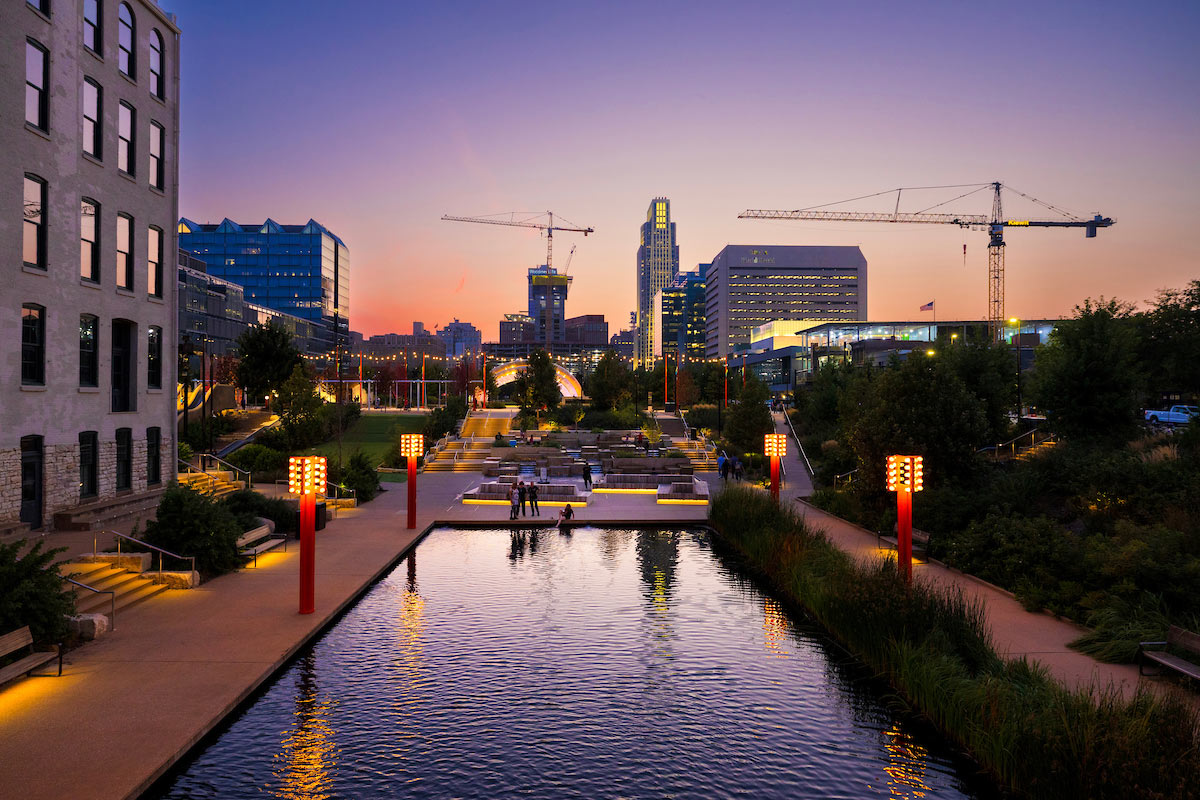The downtown Omaha skyline as seen from the renovated Gene Leahy Mall, with construction cranes on the horizon.