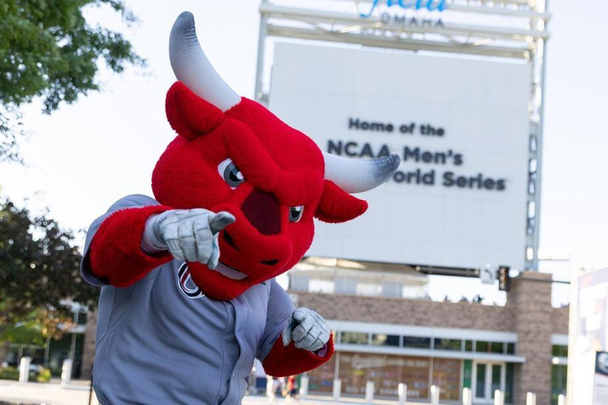 Durango poses in front of the College World Series sign.