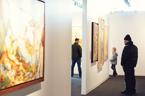 A student and partner examine artwork inside a gallery during a civic engagement project.