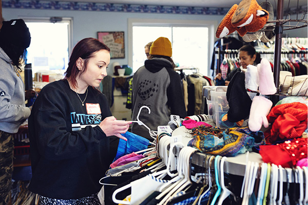 A student sorts clothing donations at a community organization.