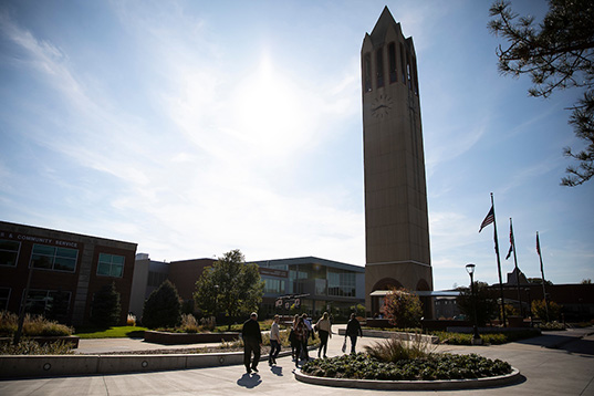 People walking near the Henningson Memorial Campanile