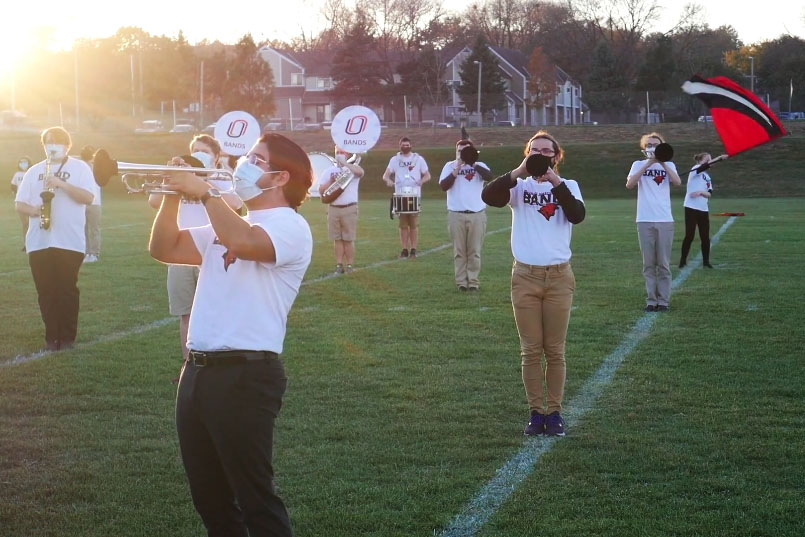 UNO musicians and color guard members on the field.