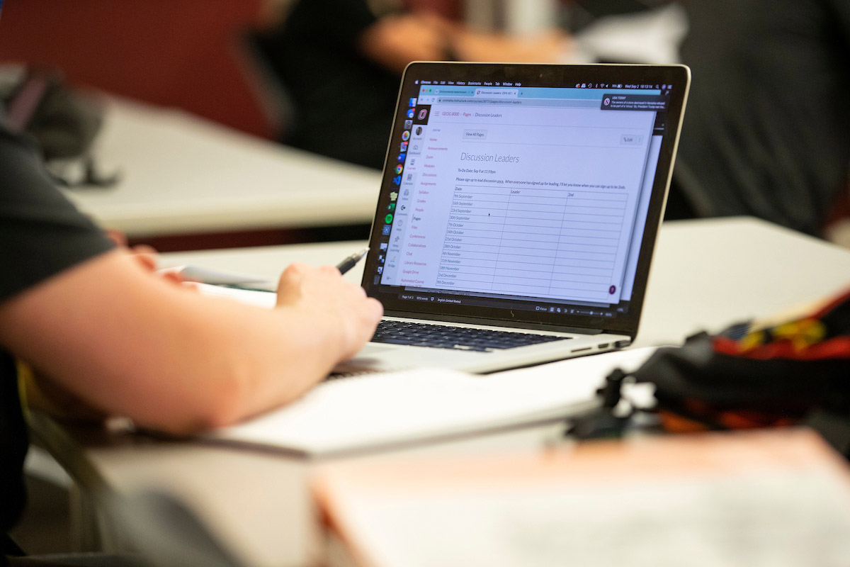 Student on their laptop with a discussion leaders page on their screen