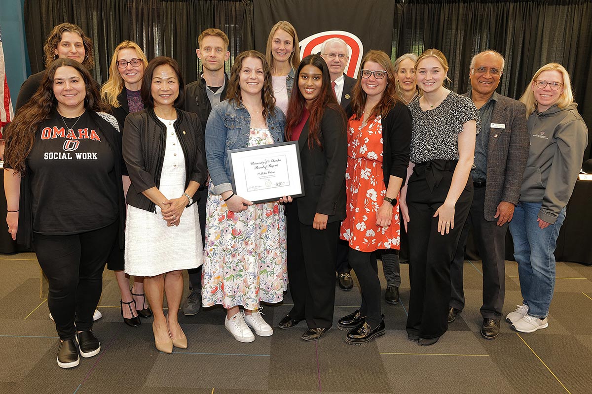 Pictured: (Back row) Ellen Rice, Assistant Director; Susan Reay, Director of the Grace Abbott School of Social Work; Justin Olson, recipient's husband; Kersten Borer, Instructor; University of Nebraska (NU) System President Jeffrey P. Gold, M.D.; Konnie Kirchner, Field Practicum Coordinator; Henry D'Souza, Graduate Program Chair; Michelle Manning, Field Practicum Specialist; (Front row) Theori Kenny, Field Practicum Specialist; UNO Chancellor Joanne Li, Ph.D., CFA; Alisha Olson, recipient; Regent Adidam; Katie Robbins, Senior Outreach Coordinator; and Meghan Witte, Graduate Assistant.