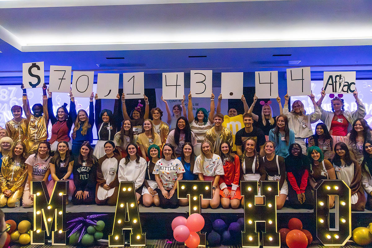 Dance Marathon participants holding up the final tally.