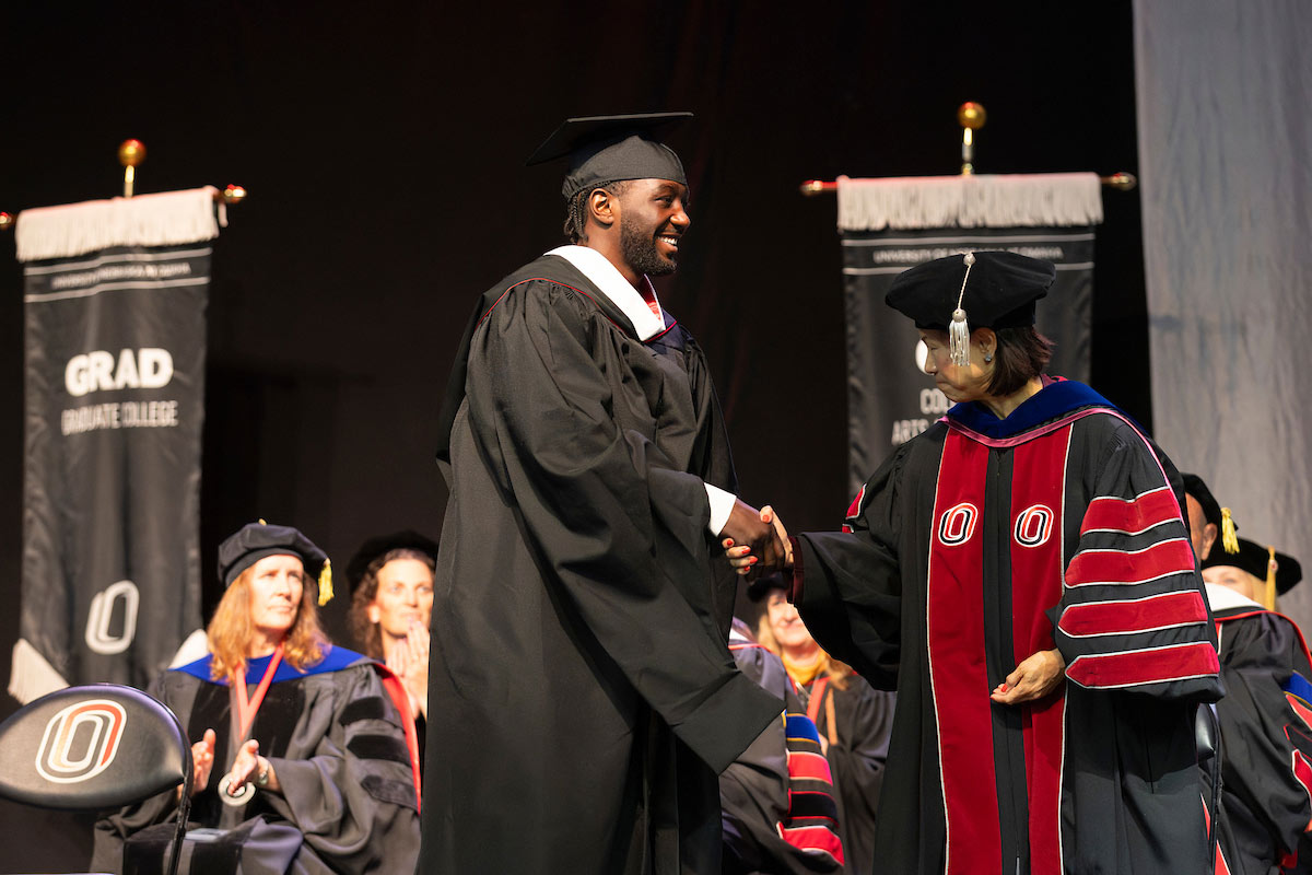Undefeated world championship boxer Terence “Bud” Crawford is treated by University of Nebraska at Omaha chancellor Joanne Li before he speaks at commencement.