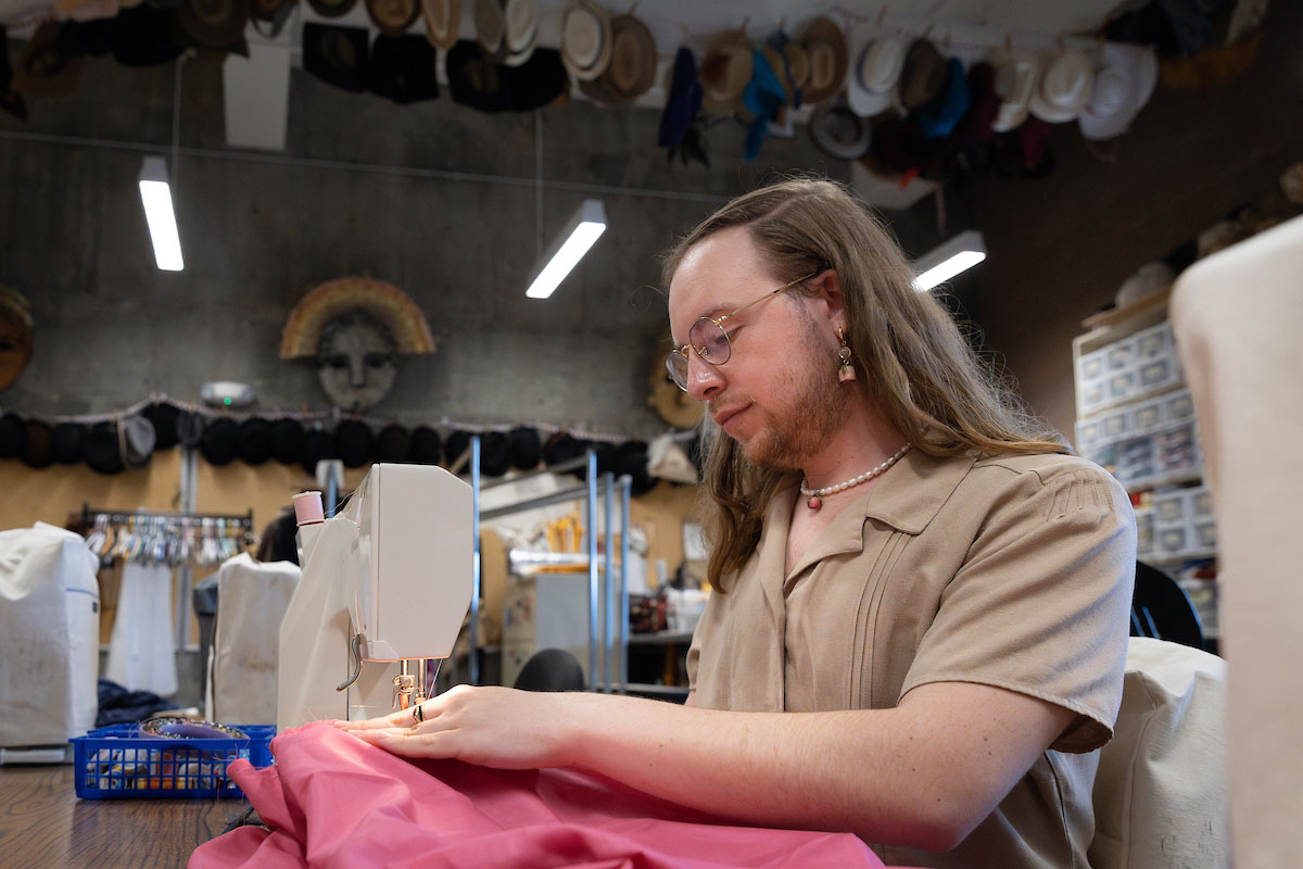 UNO senior Thomas Rowe sews in the costume shop in the College of Communication, Fine Arts and Media.