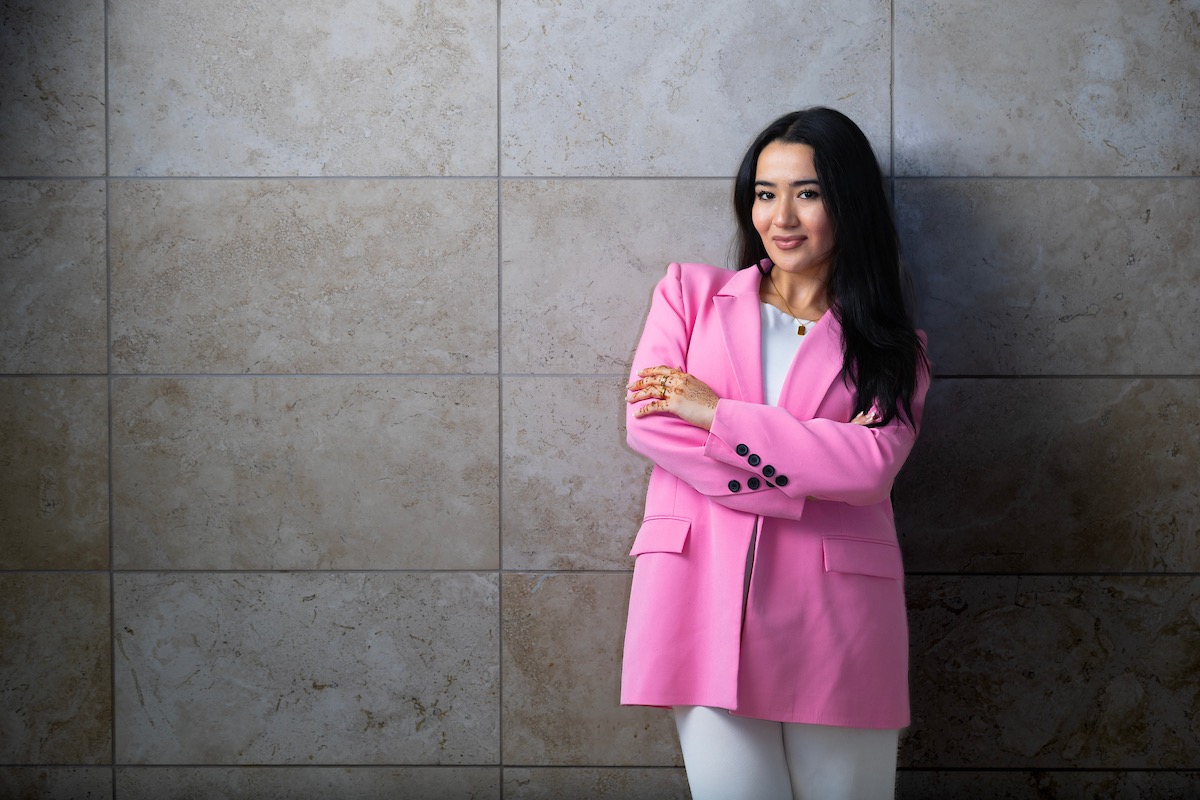 Shohina Sultonova poses inside of Mammel Hall, home to the UNO College of Business Administration (CBA).