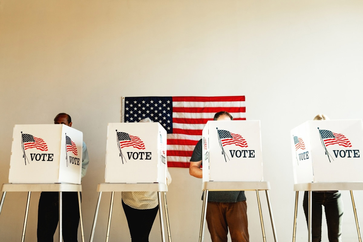Diverse people in line to vote at US election day.