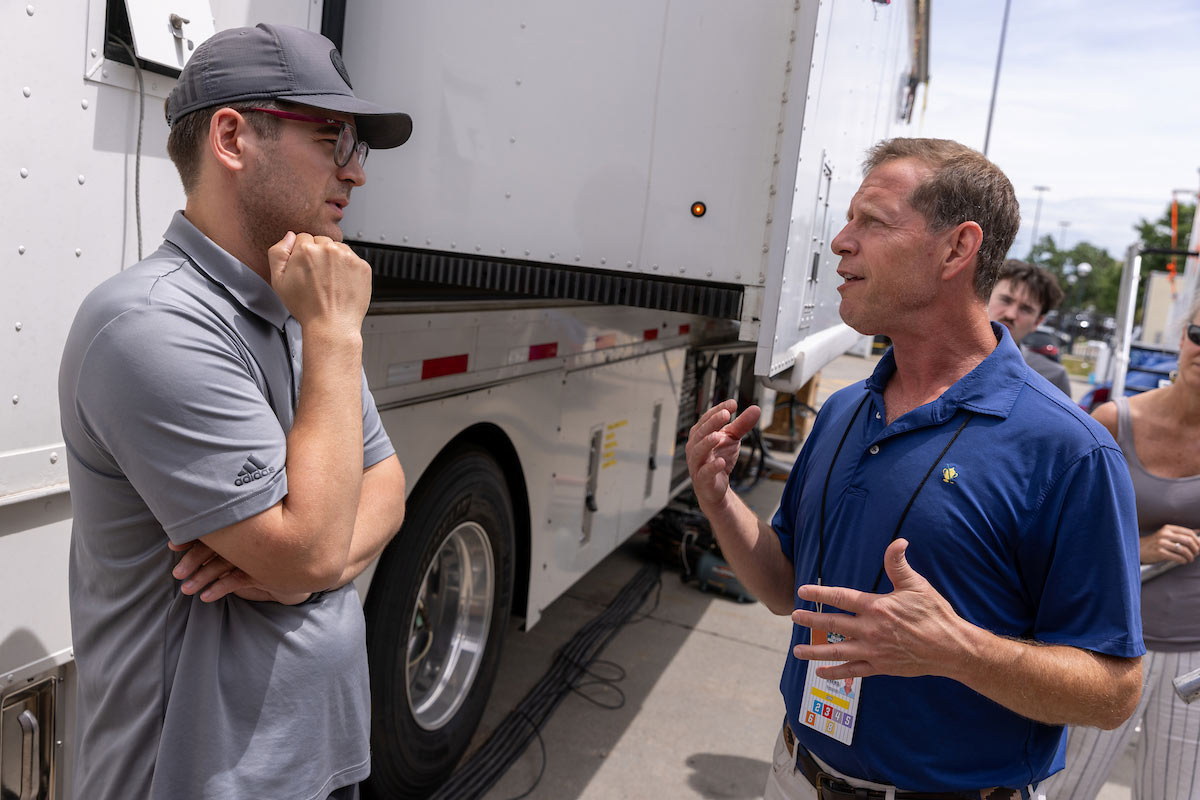 UNO students and faculty explore ESPN's production trucks during the Men's College World Series, learning about the technology and teamwork behind live sports broadcasts. Photo: Jeremy Chretien, Office of Strategic Marketing and Communication.