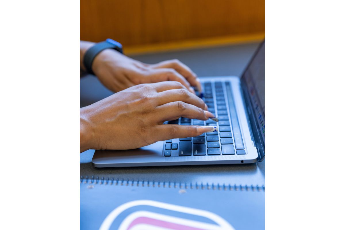 Kiera Kelly types on a laptop.