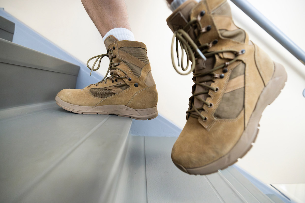 A subject tests a FlyBand® ExoBoot prototype by walking up a flight of stairs at the University of Nebraska at Omaha Biomechanics Research Building.