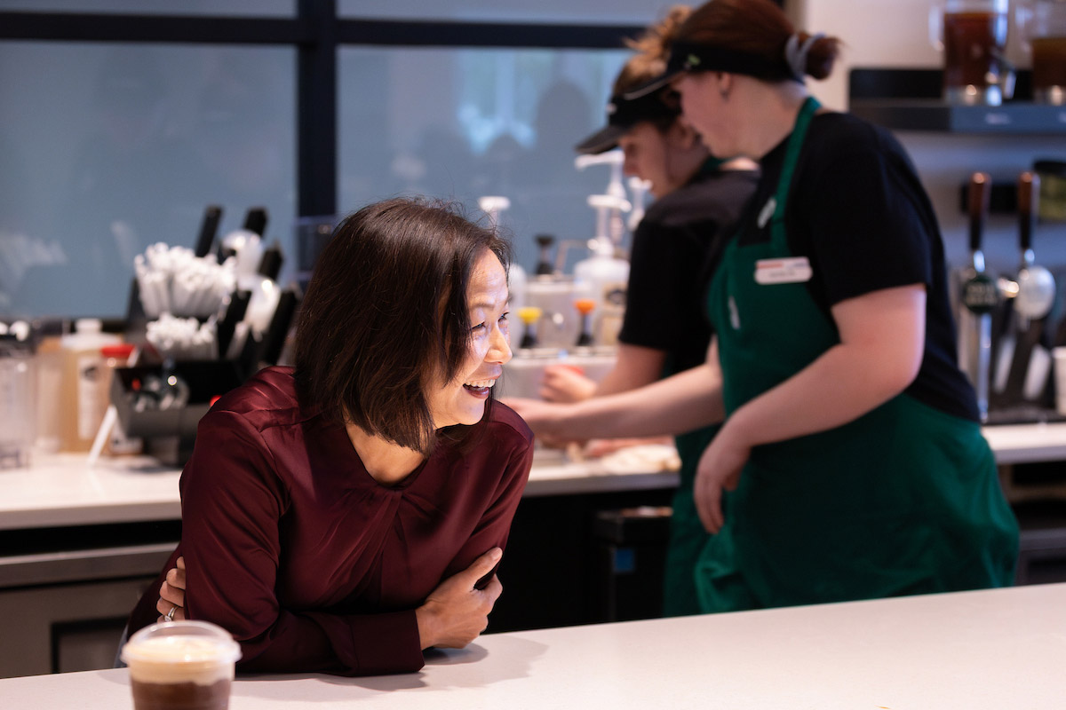Chancellor Joanne Li laughs while chatting at the counter inside UNO’s Criss Library Starbucks during Coffee Talk with Spirit and Tradition.