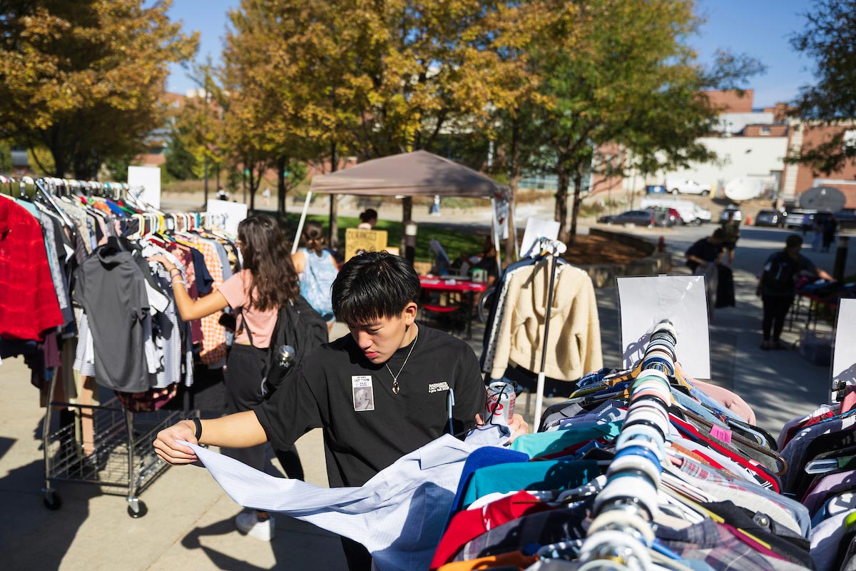 Students browse outdoor clothing racks under sunny skies at the Durango’s Outfitters free closet event on campus.