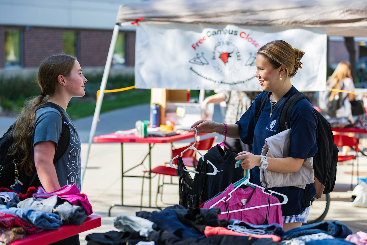 Students chat as they browse clothing and accessories