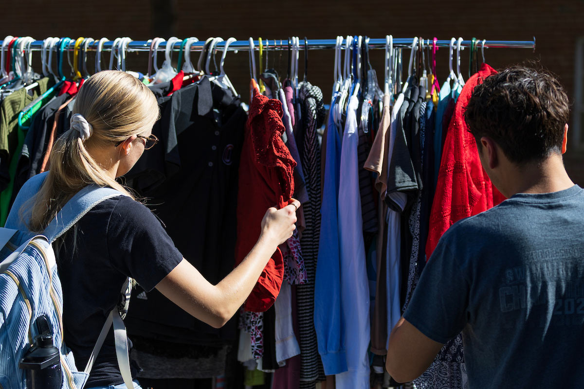 Students browse a rack of assorted shirts and tops at the Durango’s Outfitters pop-up closet.