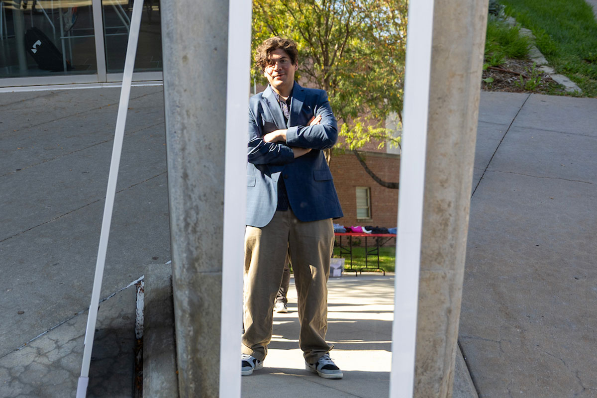 A student examines their new outfit in the mirror