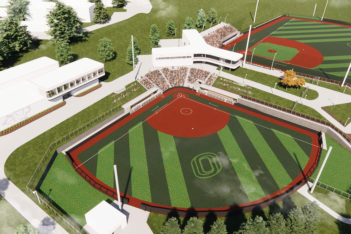 A bird’s-eye view of two fields with spectator seating, pathways, and landscaped surroundings.