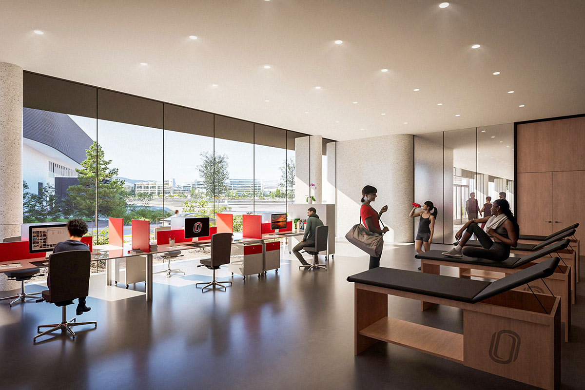 Students and staff use an open sports medicine and academic support area with treatment tables and large windows.