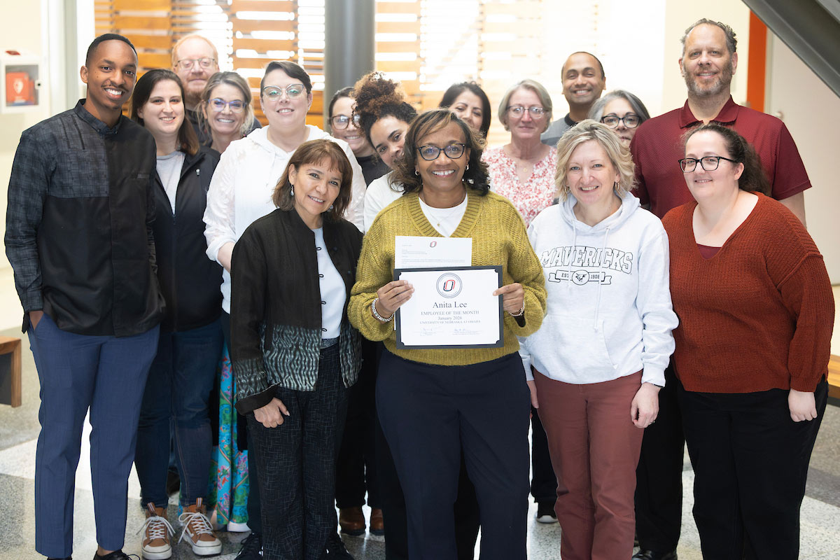 Anita Lee celebrates her award with her colleagues.