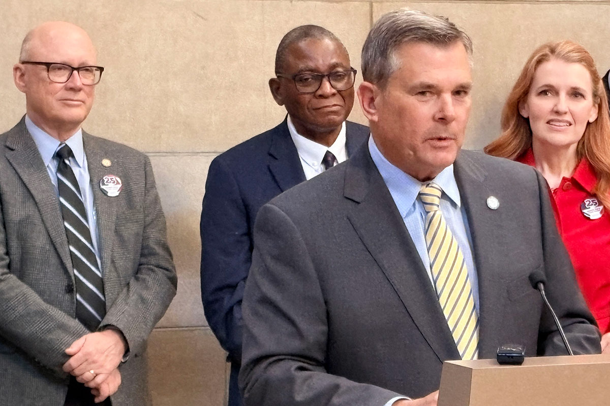 Individuals gather to speak at the anniversary celebration.