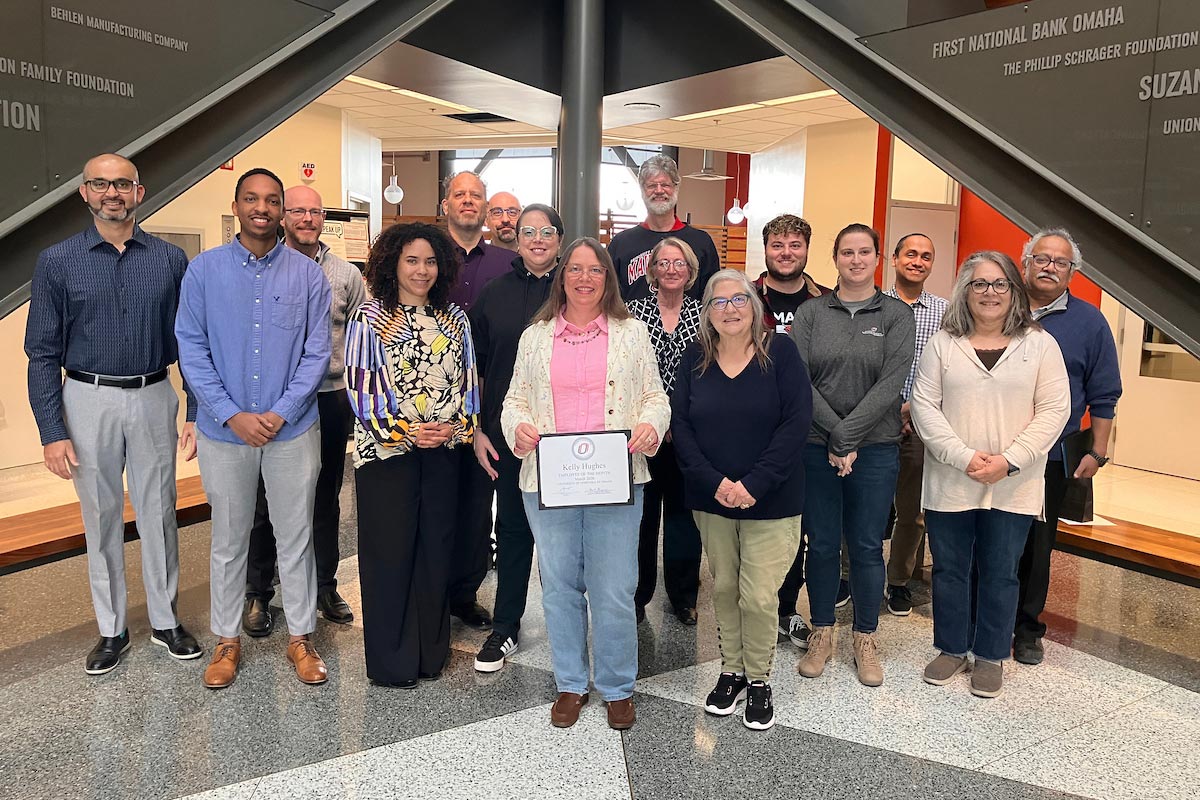Kelly Hughes celebrates his award with her colleagues.