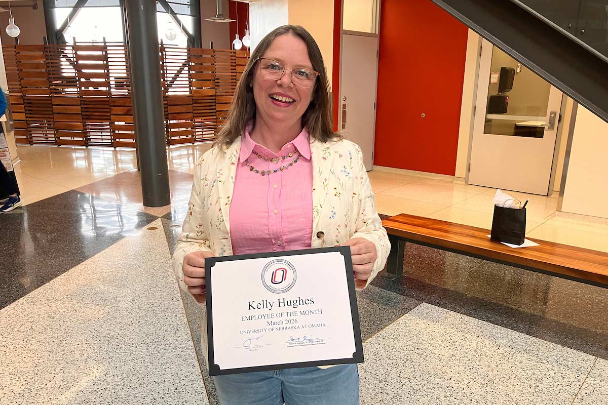 Kelly Hughes poses with her Employee of the Month certificate.