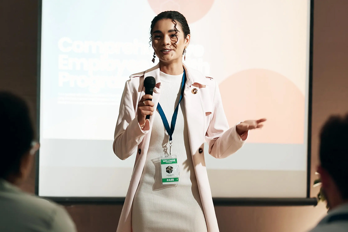 Promo image from American Startup of a women talking to an audience.