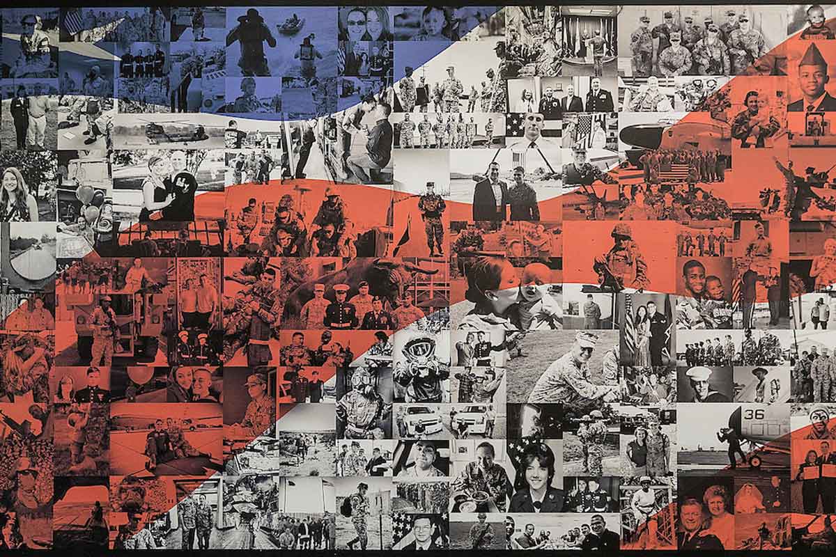 A red, white, and blue photo mural sits outside the Military-Connected Resource Center (MCRC).