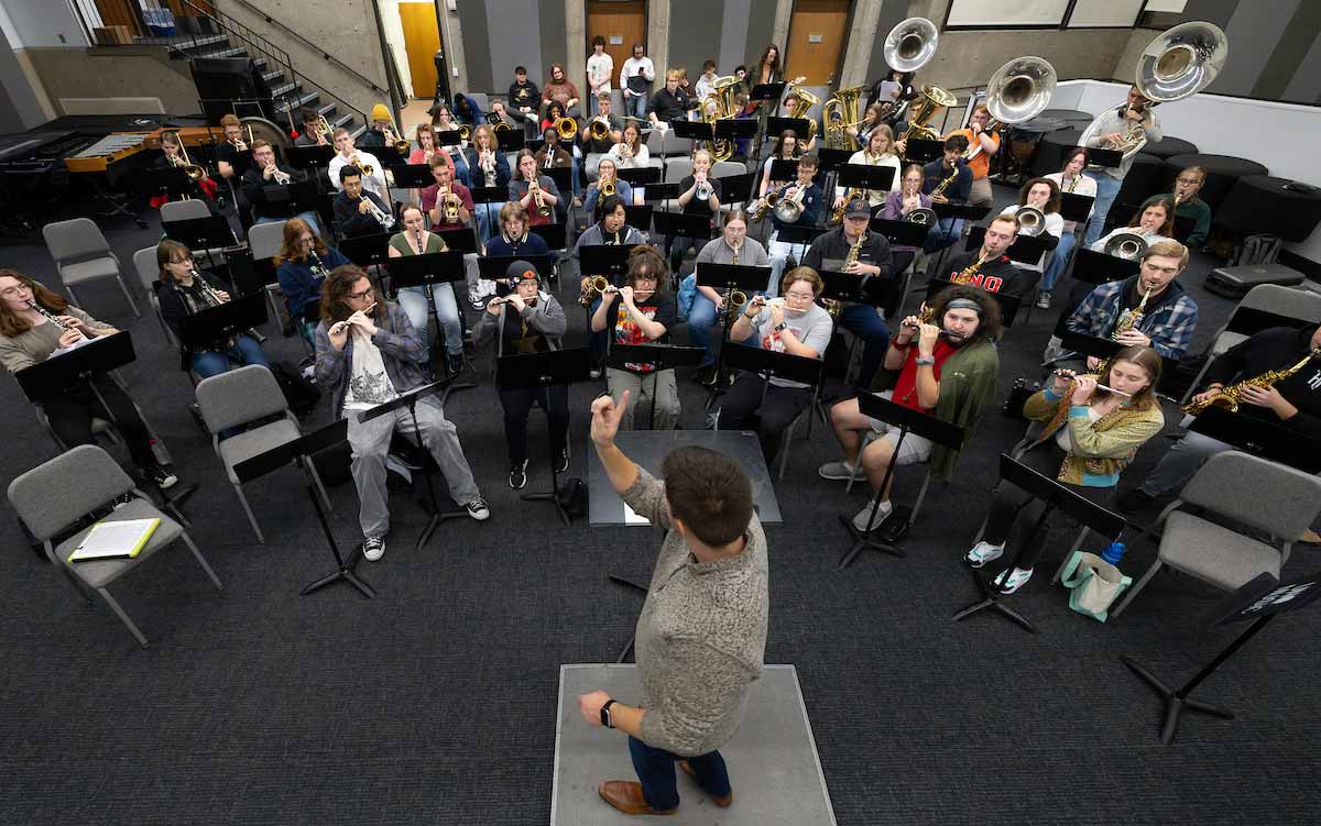 Conductor hosting band practice.  