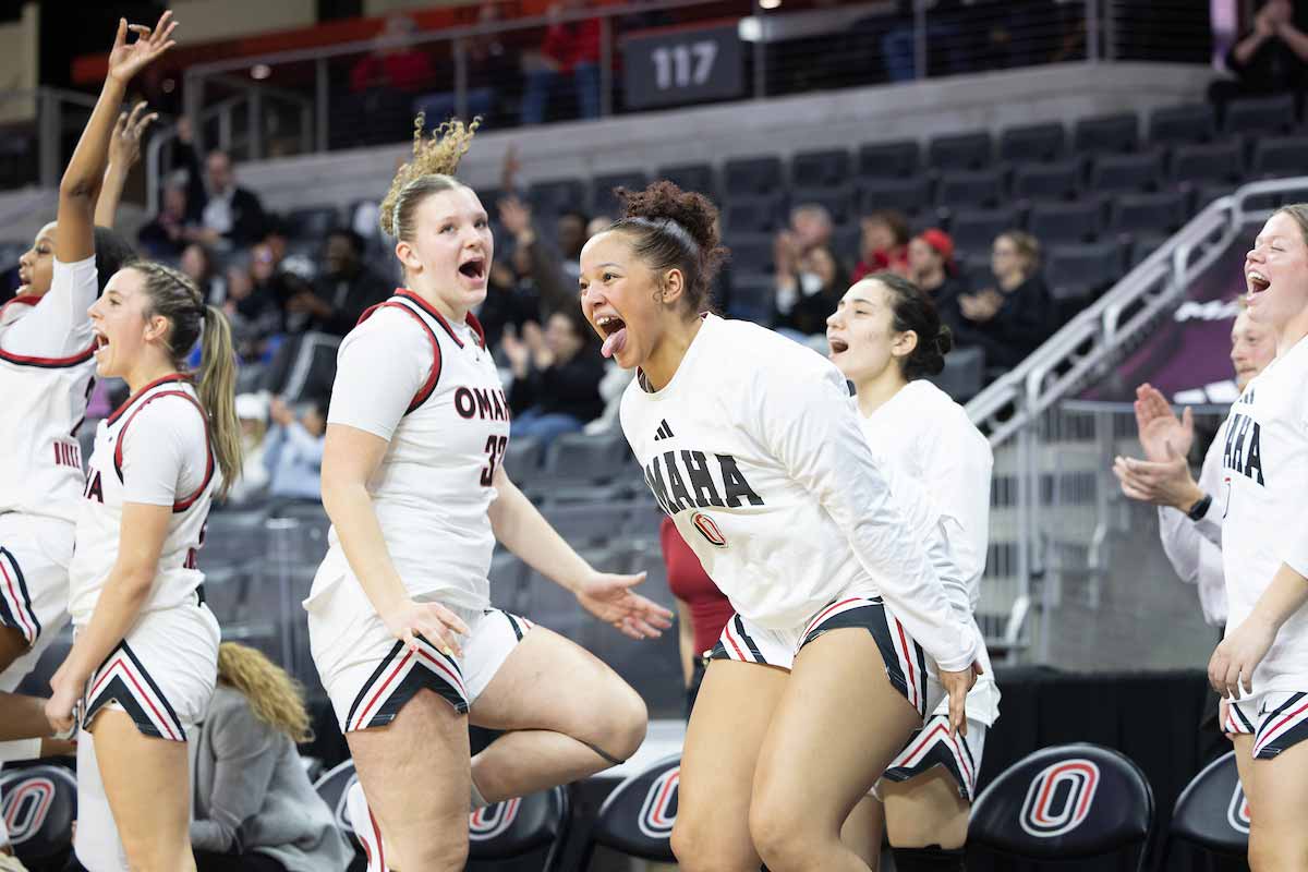 Lillian Merow, center left, and forward Erikka Gooden, center right, lead the bench in celebration