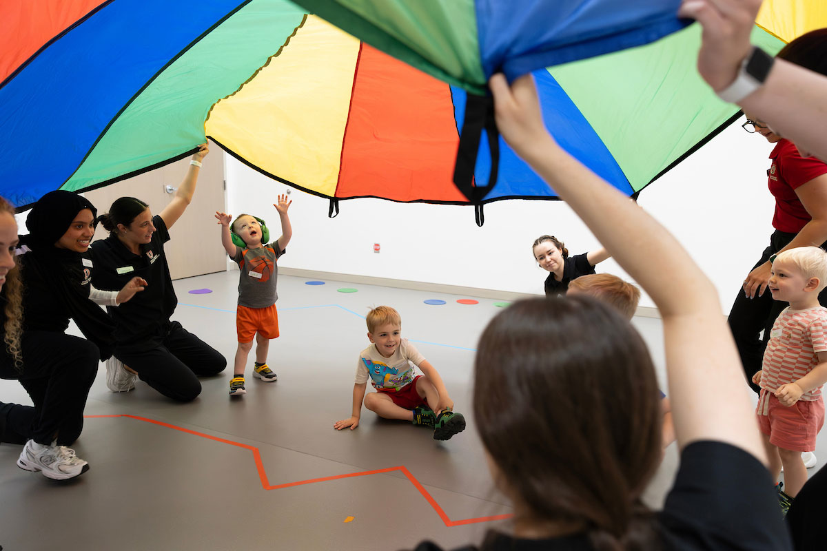 Speech-Language Pathology Program graduate students and Kinesiology undergraduate students with the Special Olympics Young Athletes program work with two to four-year-olds at the Health Science Collaborative (HSC) in the University of Nebraska at Omaha’s School of Health & Kinesiology in Omaha, Nebraska, on Tuesday, June 9, 2026. As a team, the students were working to improve the children’s reading, language, and gross motor skills. (Ryan Soderlin/UNO Marketing and Communications)