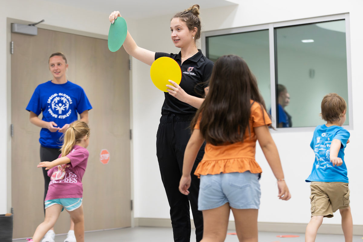 Tory Carrick (right), a graduate student in the Speech-Language Pathology program, and Julia Thomas (left), a kinesiology undergraduate, work with children at the Young Athletes Program at the Health Science Collaborative (HSC) in the University of Nebraska at Omaha’s School of Health & Kinesiology in Omaha, Nebraska, on June 11, 2026. (Ryan Soderlin/UNO Marketing and Communications)