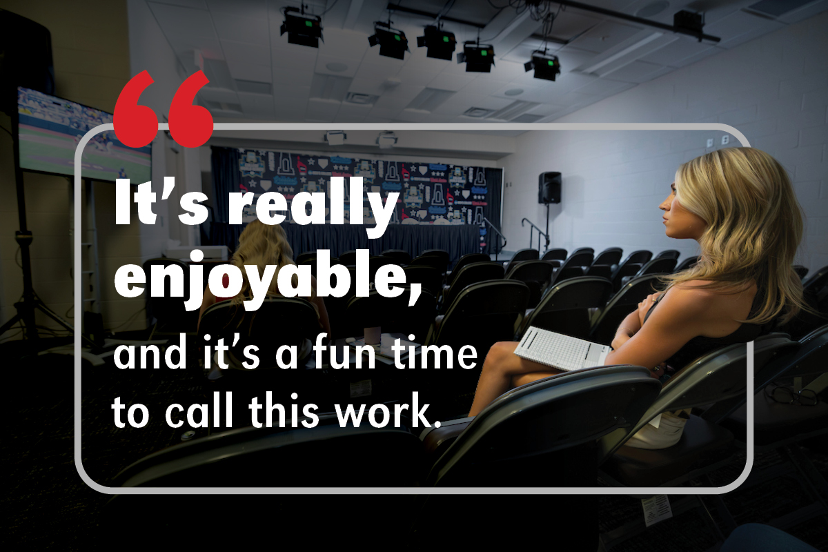 Avarie sits in the press room watching the baseball game with text that reads "It's really enjoyable, and it's a fun time to call this work." Photo by Ryan Soderlin