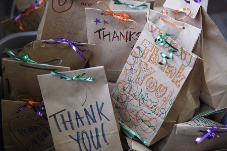 Decorated paper lunch sacks with the words thank you.