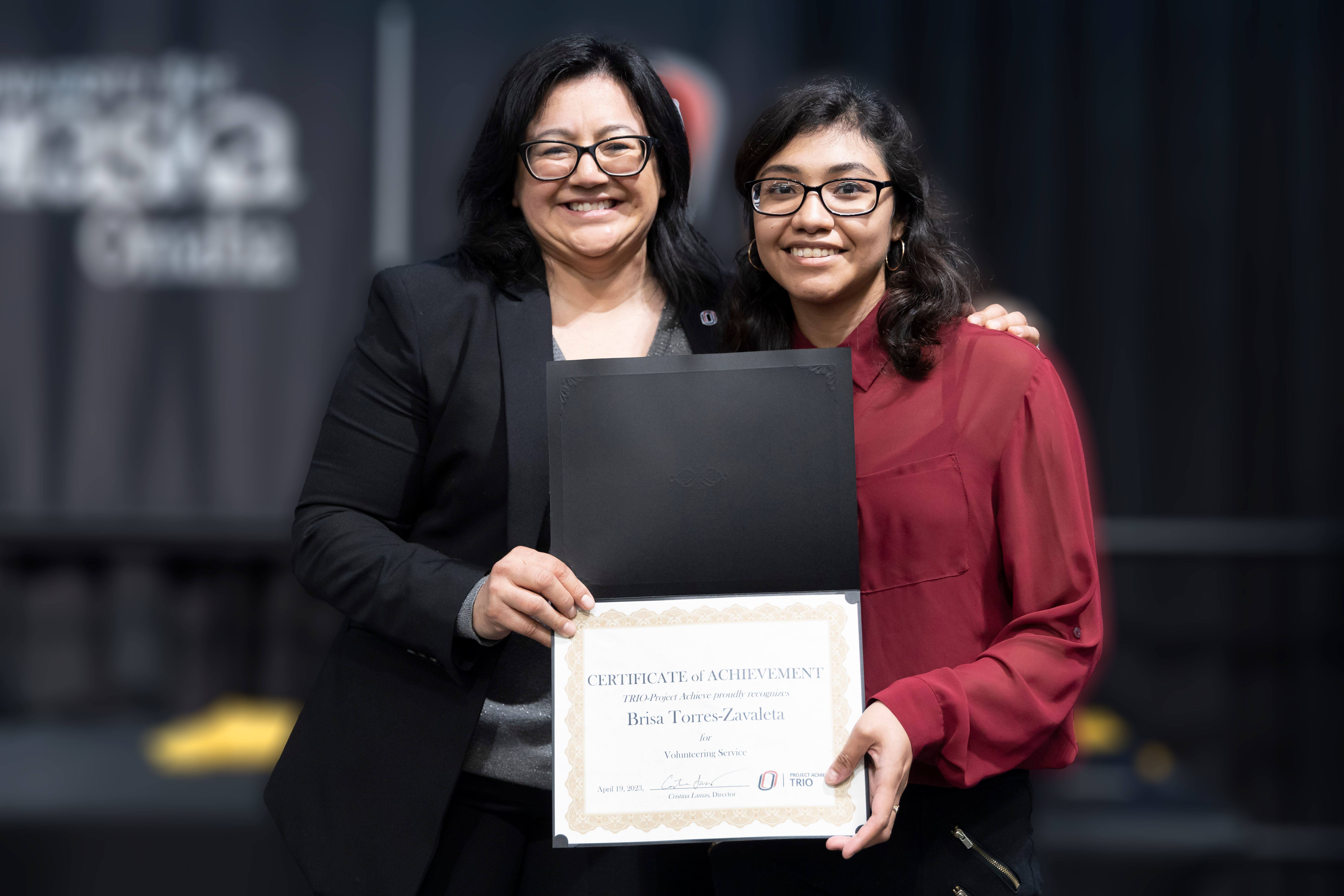 Student receiving certificate from program director.
