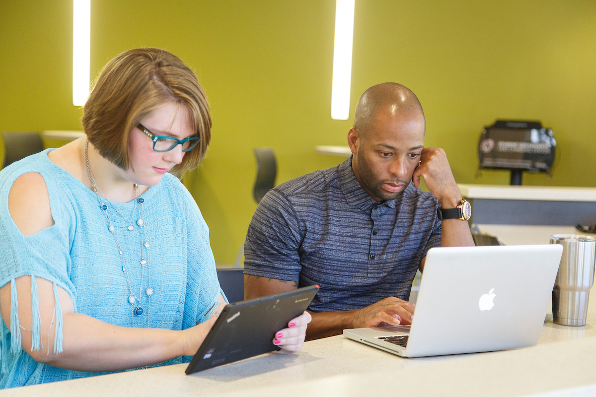 two students studying on a laptop and tablet