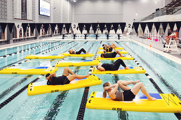 Students participate in a water yoga class at the campus pool.