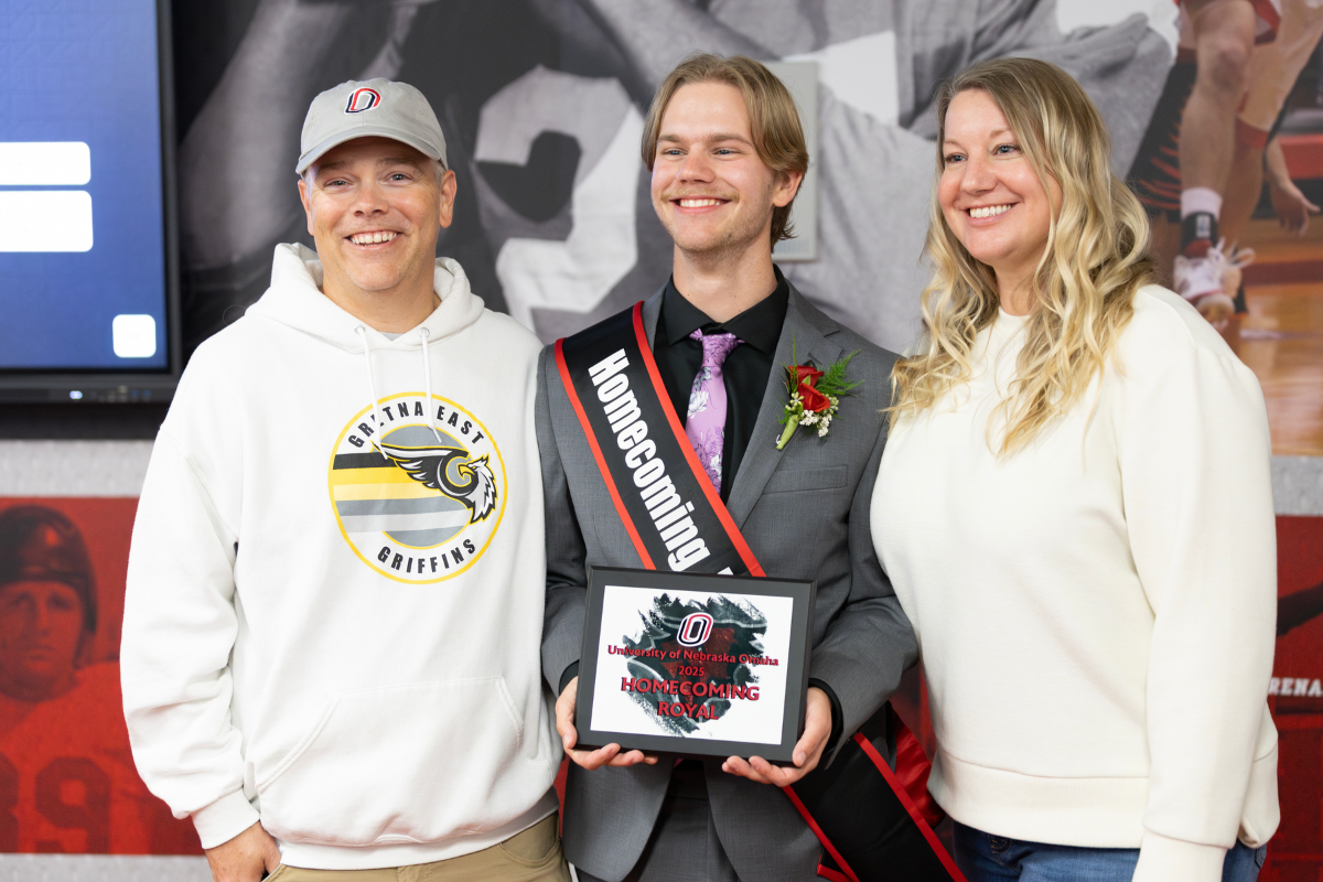 UNO student celebrating homecoming royalty win with family