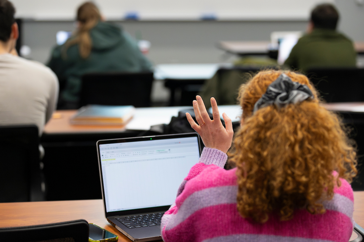 Student raising hand in class.